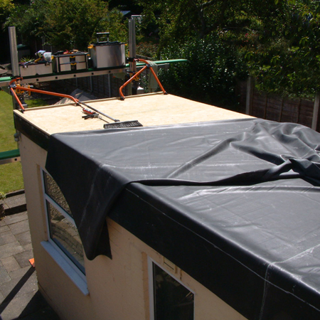 Image of Reechcraft PowerPole attached to roof allowing Firestone EPDM rubber to be hoisted onto the roof