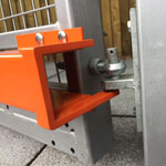 Mk8 left side anti lift fitted to a metal pedestrian gate showing anti lift positioned under the post hook gate swinging open 